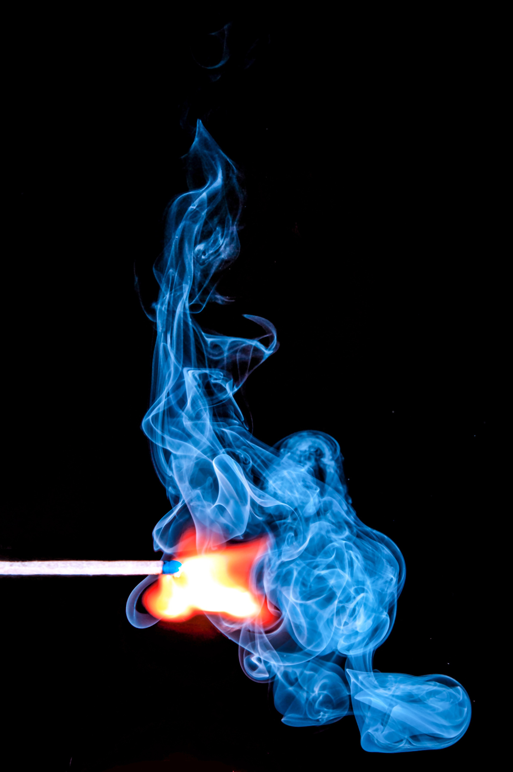 Lighted Match With Smoke on Black Background